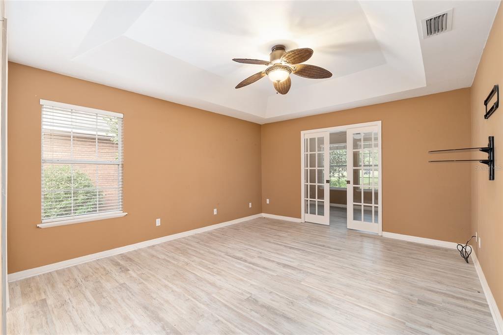 10160 Southwest 48th Place Gainesville, FL 32608 - Photo 19 of 68 a view of an empty room with a window and wooden floor