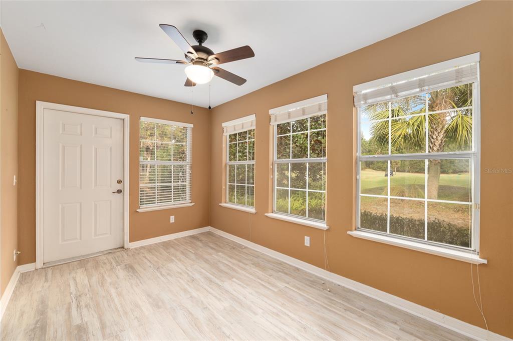 10160 Southwest 48th Place Gainesville, FL 32608 - Photo 23 of 68 a view of an empty room with a window and wooden floor