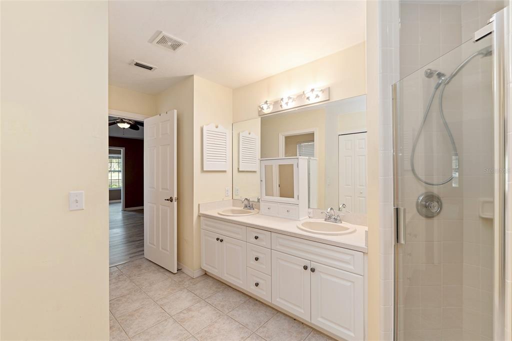 10160 Southwest 48th Place Gainesville, FL 32608 - Photo 27 of 68 a spacious bathroom with a double vanity sink shower and a mirror