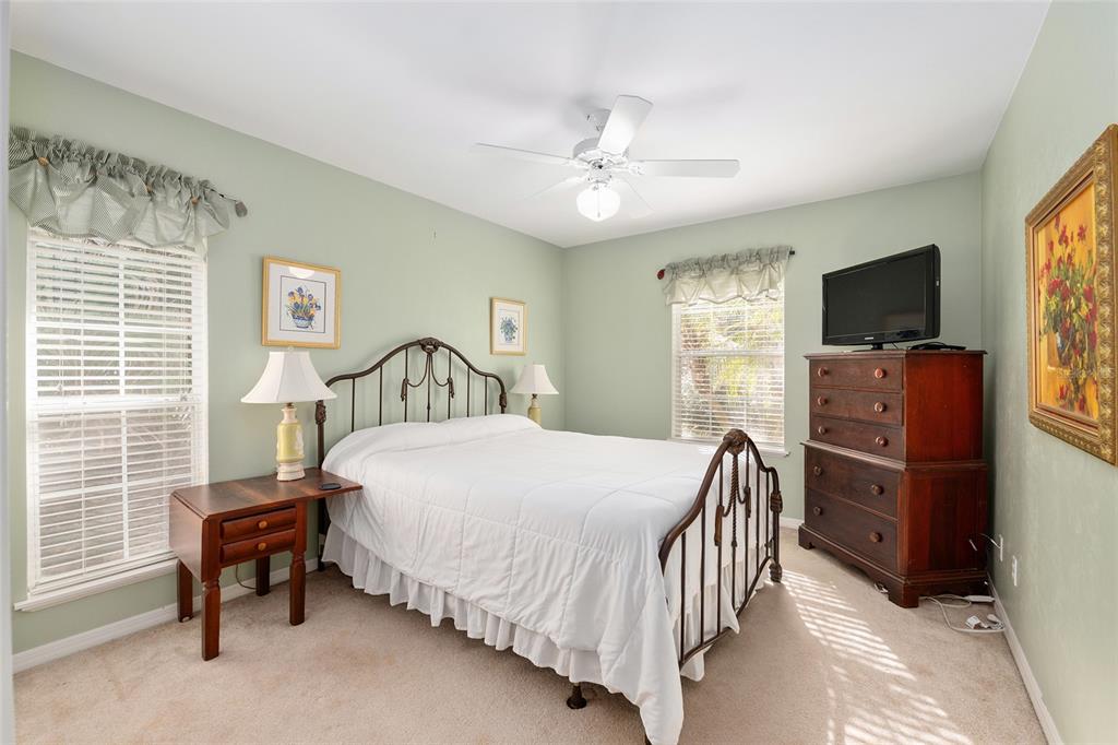 10160 Southwest 48th Place Gainesville, FL 32608 - Photo 31 of 68 a bedroom with a bed and a flat tv screen on dresser