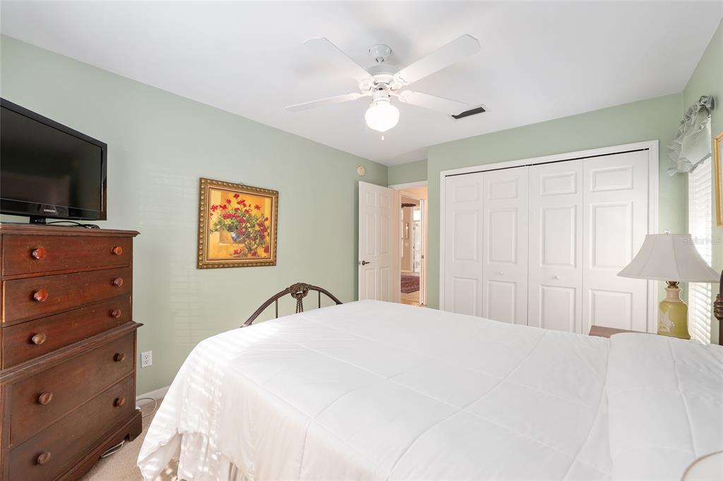 10160 Southwest 48th Place Gainesville, FL 32608 - Photo 32 of 68 a bedroom with a bed and a flat screen tv