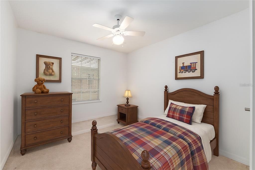 10160 Southwest 48th Place Gainesville, FL 32608 - Photo 36 of 68 a bedroom with a bed and a chandelier