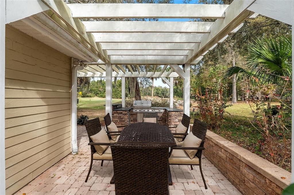 10160 Southwest 48th Place Gainesville, FL 32608 - Photo 46 of 68 a view of a patio with table and chairs and potted plants