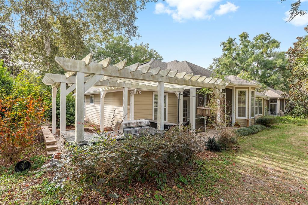 10160 Southwest 48th Place Gainesville, FL 32608 - Photo 47 of 68 a front view of a house with a garden