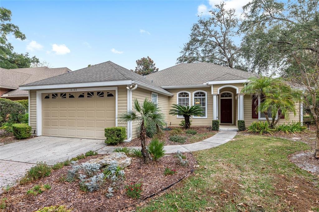 10160 Southwest 48th Place Gainesville, FL 32608 - Photo 61 of 68 a front view of a house with garden and porch
