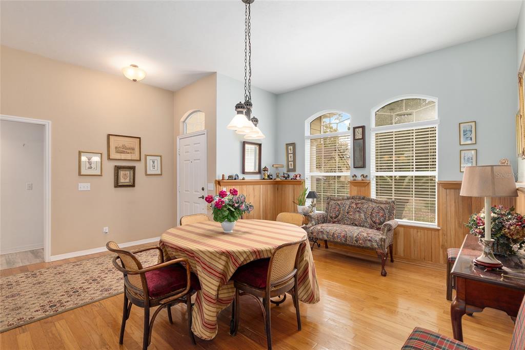 10160 Southwest 48th Place Gainesville, FL 32608 - Photo 7 of 68 a living room with furniture dining table and wooden floor
