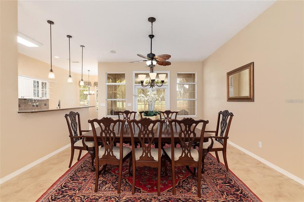 10160 Southwest 48th Place Gainesville, FL 32608 - Photo 9 of 68 a view of a dining room with furniture window and wooden floor