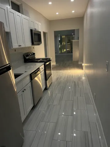a kitchen with sink a microwave and cabinets