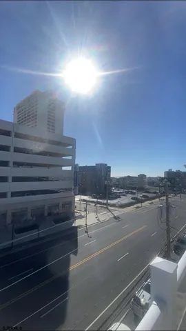 a view of a livingroom with furniture and a floor to ceiling window