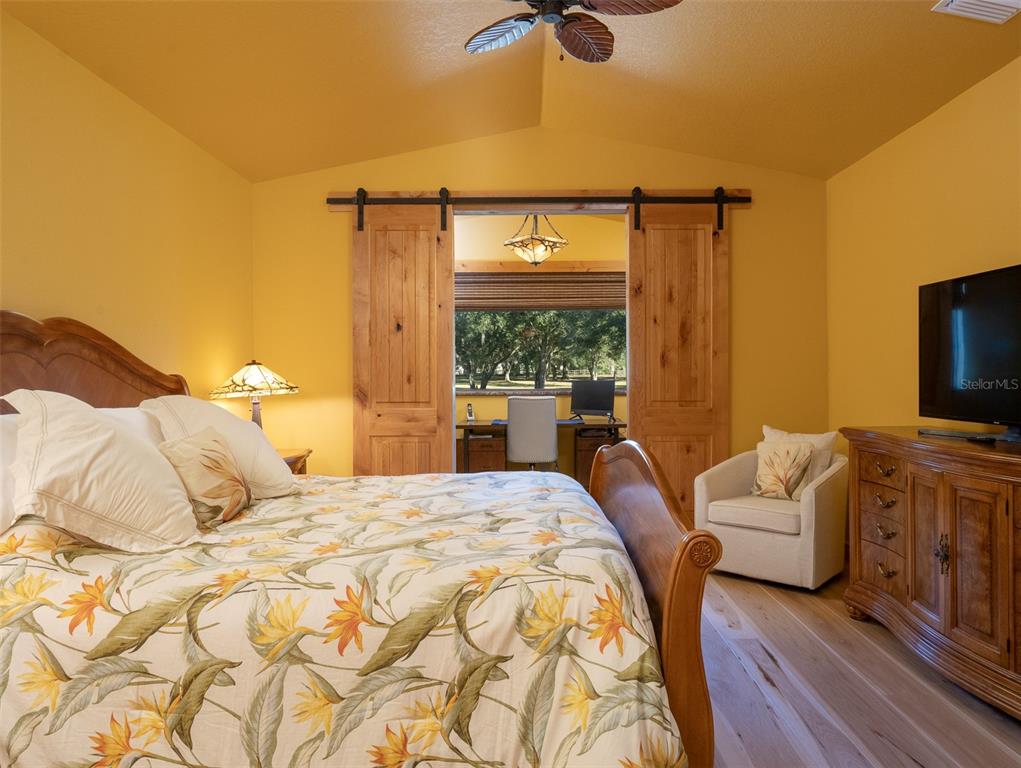 3 Carry Back Road Ocala, FL 34482 - Photo 14 of 37 a bedroom with a bed and a flat tv screen on dresser