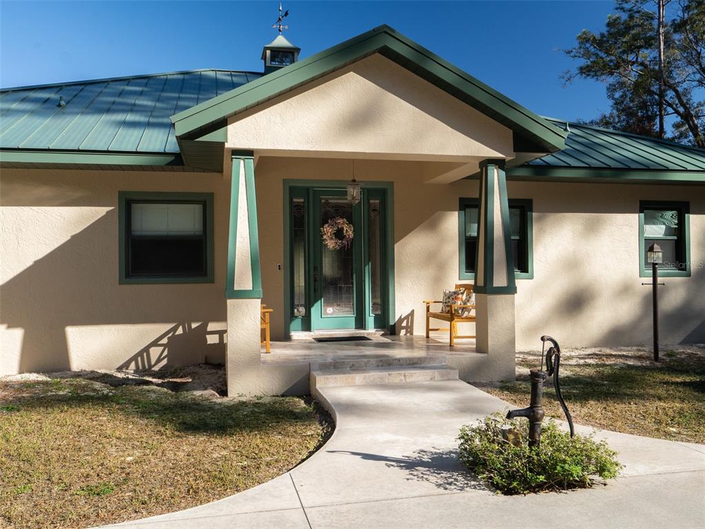 3 Carry Back Road Ocala, FL 34482 - Photo 3 of 37 a front view of a house with garden
