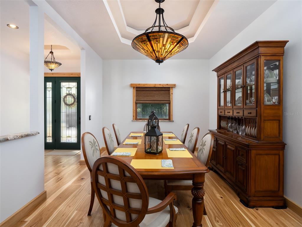 3 Carry Back Road Ocala, FL 34482 - Photo 8 of 37 a view of a dining room with furniture wooden floor and chandelier