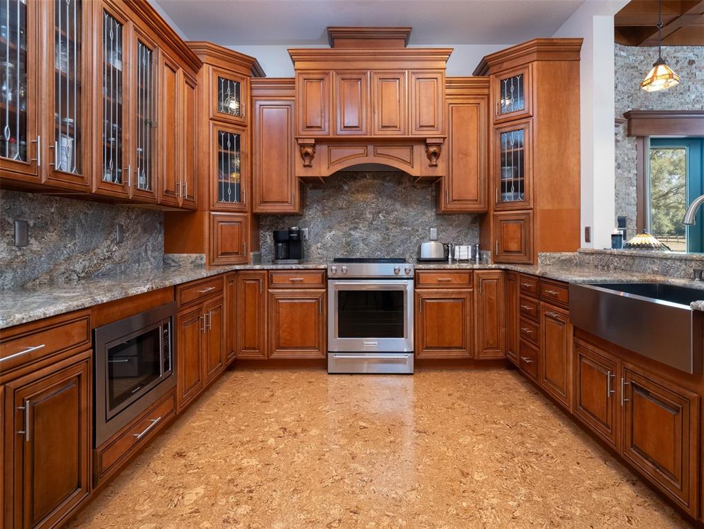 3 Carry Back Road Ocala, FL 34482 - Photo 9 of 37 a kitchen with stainless steel appliances granite countertop a stove a sink and a microwave