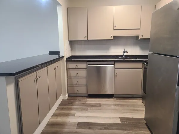 a kitchen with stainless steel appliances white cabinets and a sink