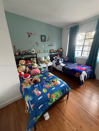 a bedroom with bed and window