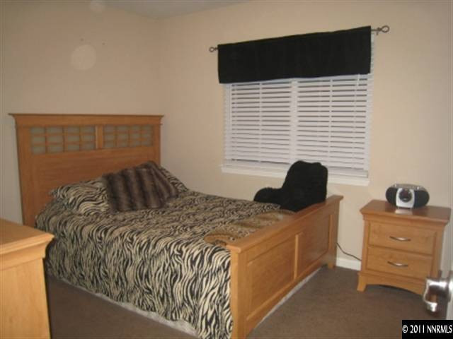 8960 Yeager Street Reno, NV 89506 - Photo 5 of 10 a bedroom with a bed and a window
