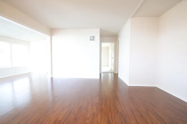 a view of a room with wooden floor