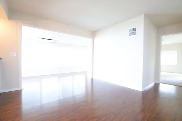 a view of a room with wooden floor