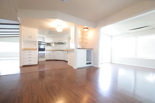 a view of a kitchen with wooden floor