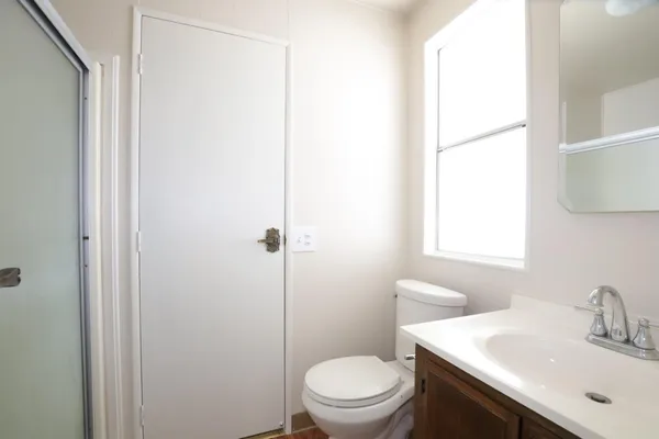 a bathroom with a toilet and a vanity
