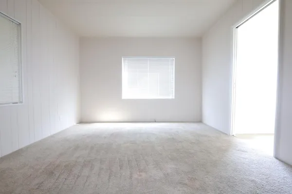 a view of an empty room and a window