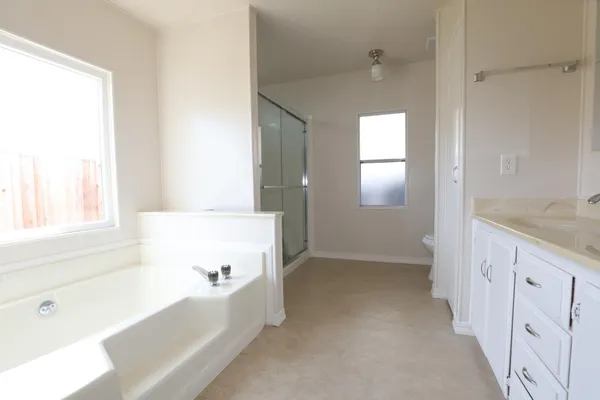 a bathroom that has a glass shower door