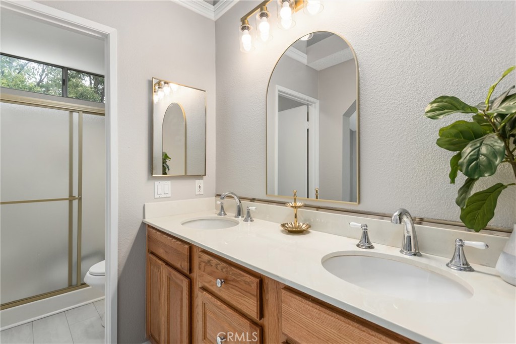 680 Indian Wells Road Banning, CA 92220 - Photo 25 of 37 a bathroom with a double vanity sink and a mirror
