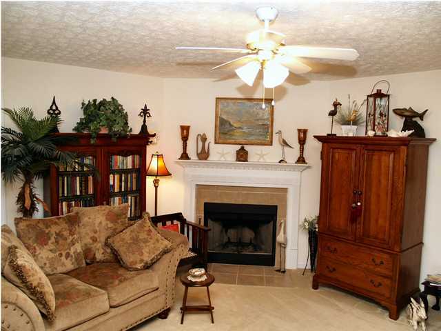 203 Bay Grove Road Freeport, FL 32439 - Photo 4 of 12 a living room with furniture a fireplace and a chandelier