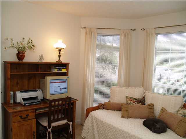 203 Bay Grove Road Freeport, FL 32439 - Photo 7 of 12 a bedroom with a bed and a potted plant