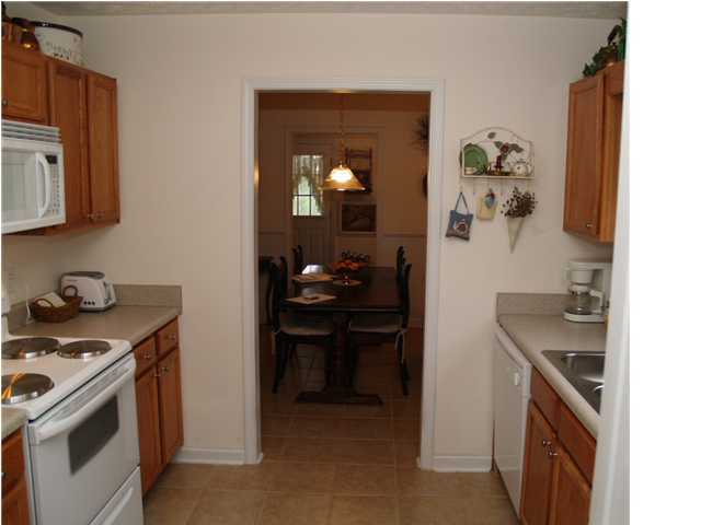 203 Bay Grove Road Freeport, FL 32439 - Photo 9 of 12 a kitchen with a sink stove and cabinets