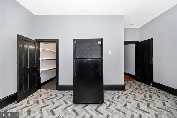 a room with a wooden floor and a bathroom