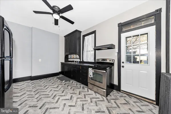 a kitchen with stainless steel appliances granite countertop a refrigerator and a stove top oven