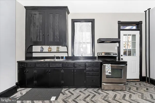 a kitchen with a stove and a refrigerator