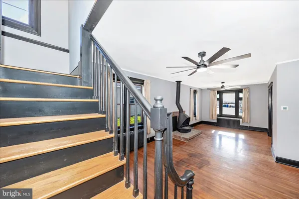 a view of entryway and hall with wooden floor