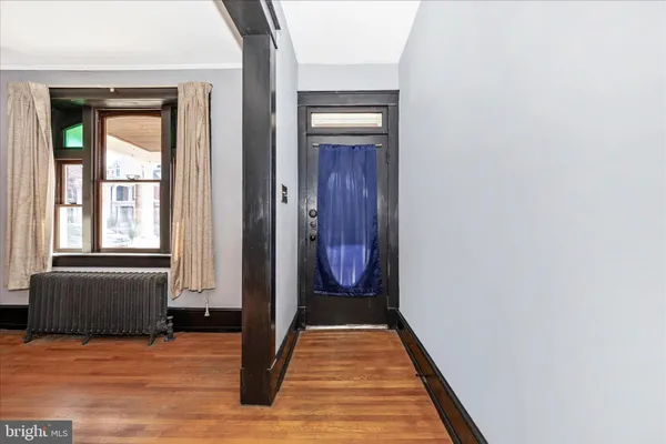 a view of front door with wooden floor
