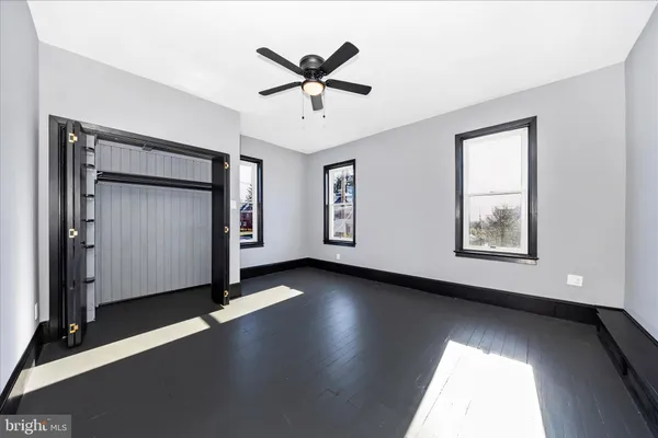a view of a livingroom with a ceiling fan and window