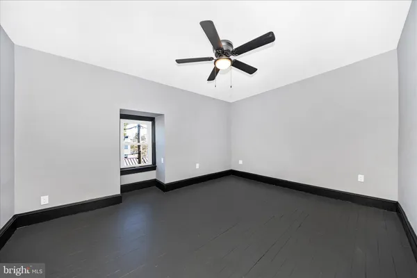 a view of a livingroom with a ceiling fan and window