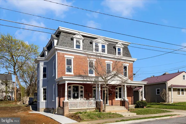 a front view of a residential apartment building with a yard