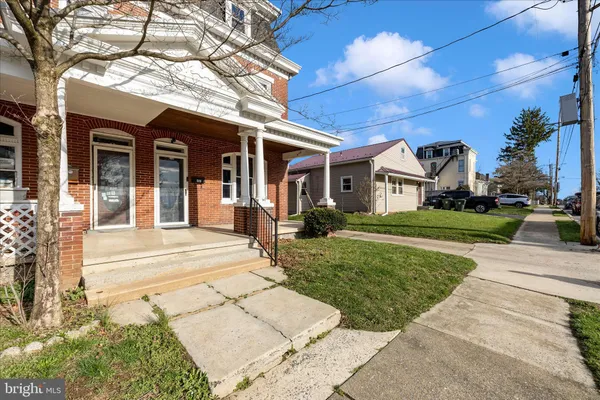 a front view of a house with a garden