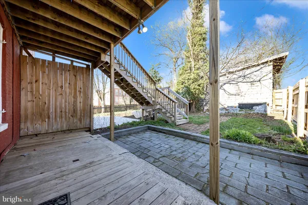 a view of balcony with wooden floor and fence