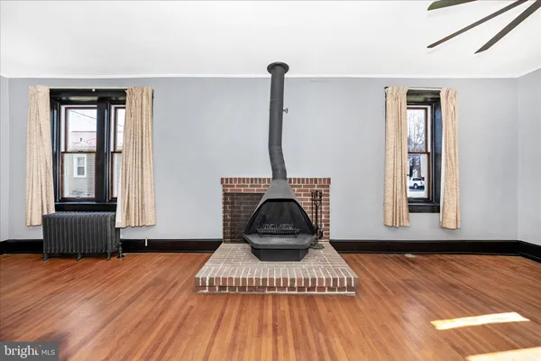 a view of a livingroom with wooden floor and stairs
