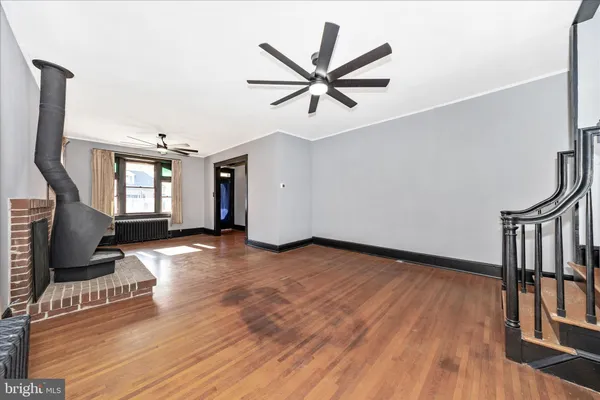 a view of a livingroom with a hardwood floor and a ceiling fan