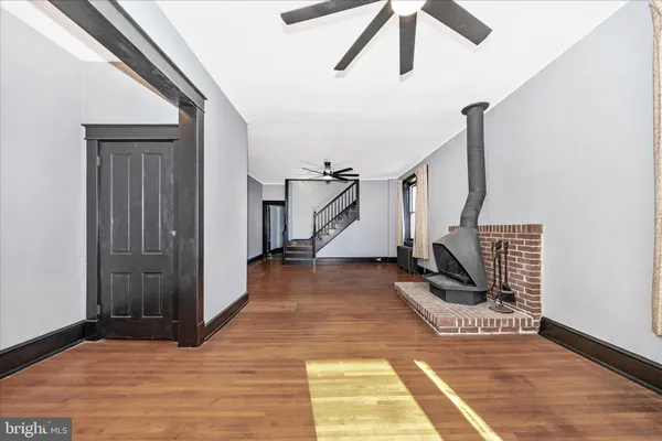 a view of entryway and hall with wooden floor