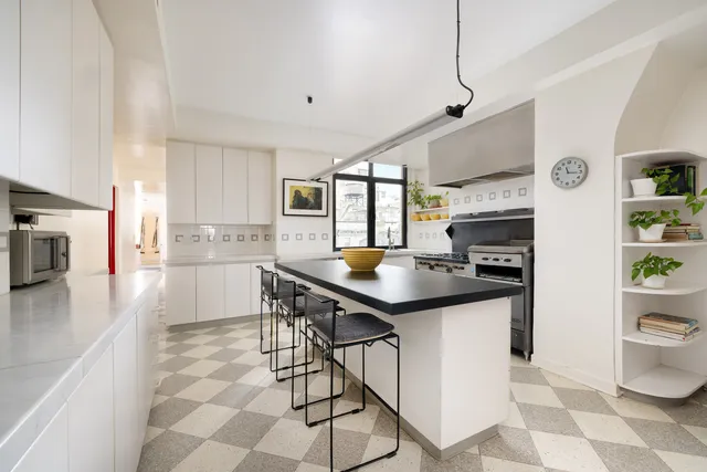 a dining room with furniture a chandelier and wooden floor
