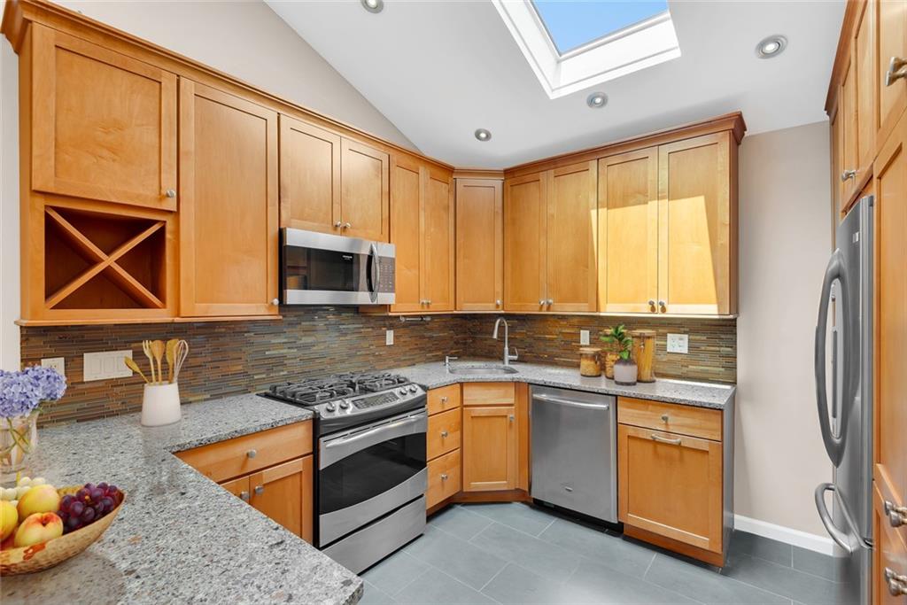 129 Bay Ridge Parkway, Unit 3 Brooklyn, NY 11209 - Photo 6 of 13 a kitchen with stainless steel appliances granite countertop a stove a sink and a microwave