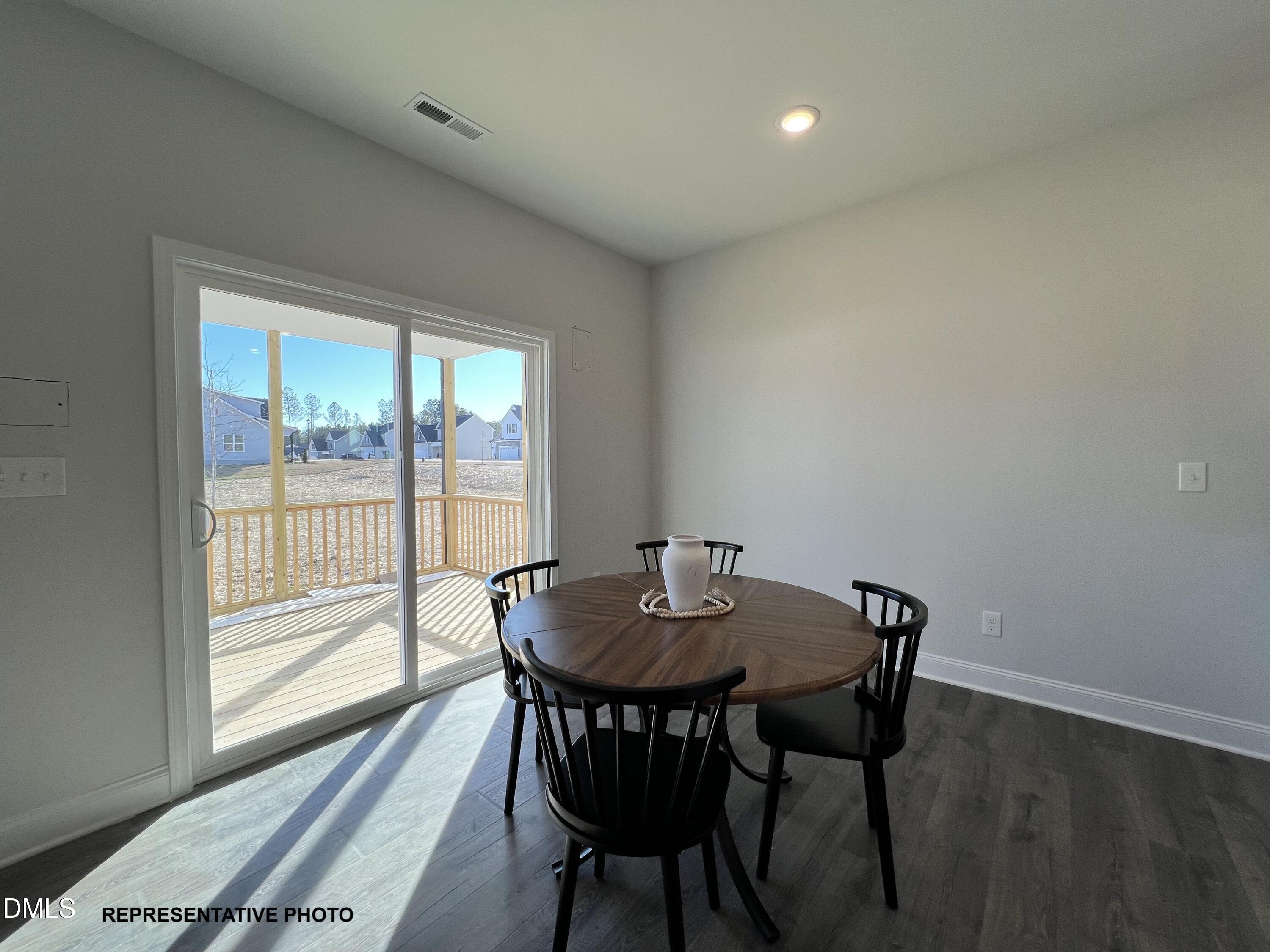 75 Cardovia Way Wendell, NC 27591 - Photo 4 of 17 a view of a dining room with furniture and wooden floor