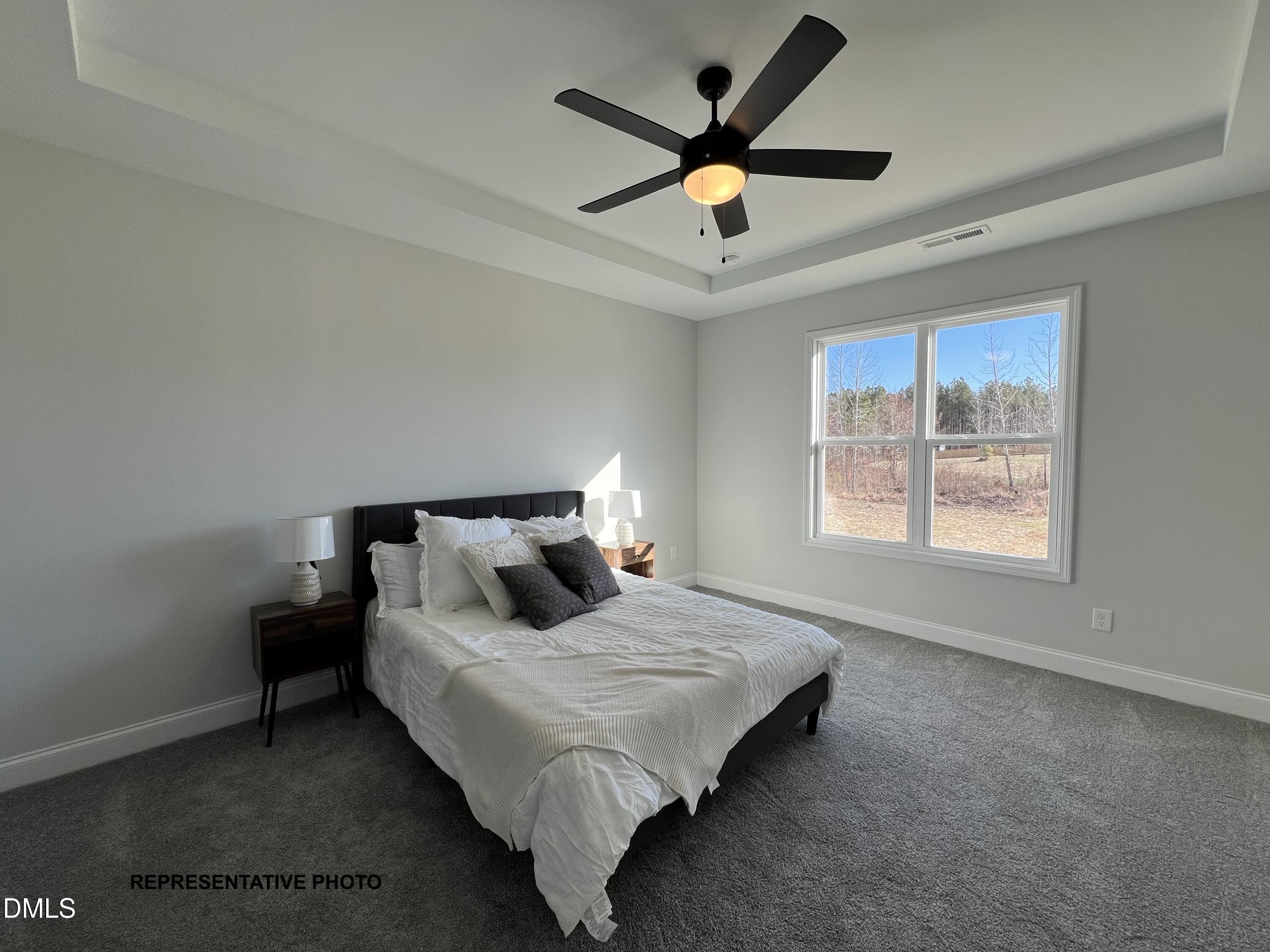 75 Cardovia Way Wendell, NC 27591 - Photo 8 of 17 a bedroom with a bed and a large window