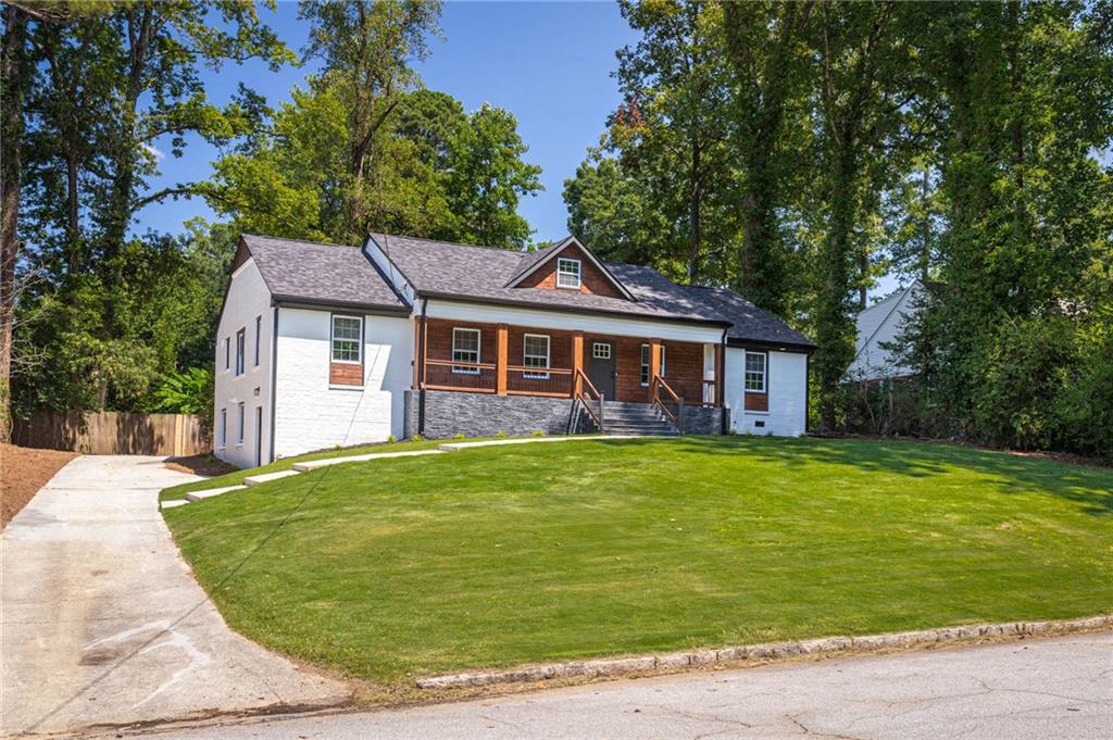 610 Glenforest Road Atlanta, GA 30328 - Photo 2 of 44 a front view of a house with a garden