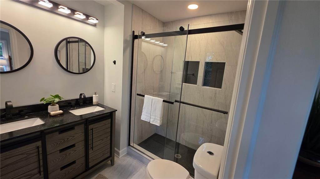 610 Glenforest Road Atlanta, GA 30328 - Photo 22 of 44 a bathroom with a double vanity sink mirror and toilet