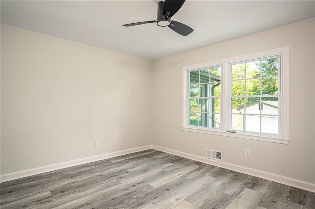 610 Glenforest Road Atlanta, GA 30328 - Photo 26 of 44 wooden floor in an empty room with a window